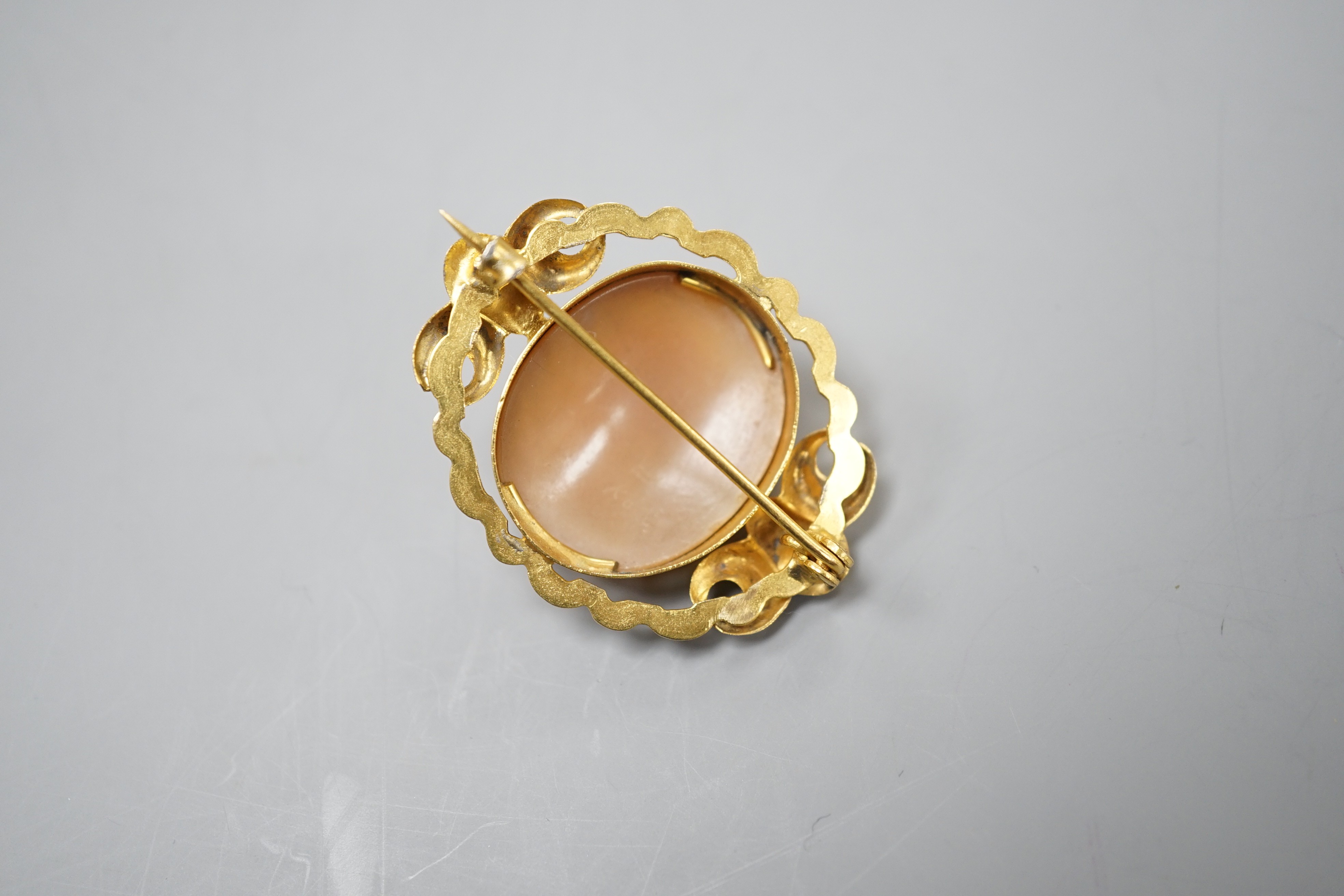 An early 20th century yellow metal mounted oval cameo shell brooch, carved with with the bust of a gentleman to sinister, 37mm, gross 7.6 grams.